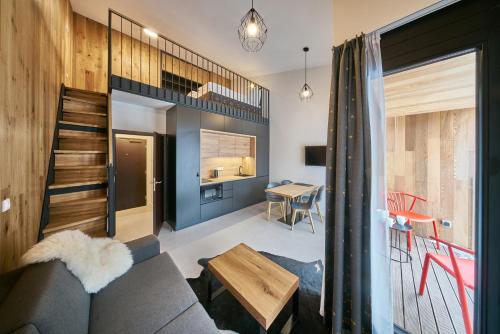 a living room with a couch and a table at Aparthotel Svatý Vavřinec in Pec pod Sněžkou