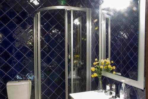 a bathroom with a shower and a sink and a mirror at Casa De Santa Comba in Cabeceiras de Basto