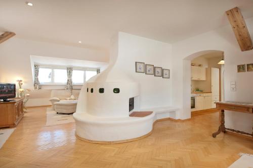 a living room with a fireplace in the middle at Villa St. Oswald in Seefeld in Tirol