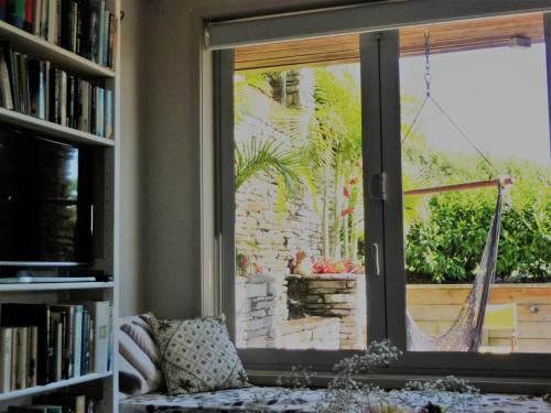 a living room with a window and a couch at The Orchard in Whakamarama