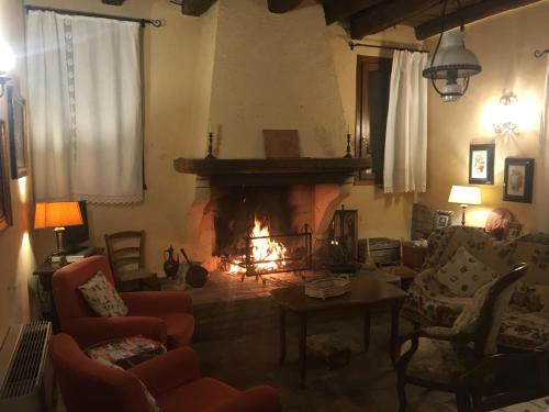 a living room with a fire in the fireplace at Agriturismo La Cascinetta in Pieve di Cento