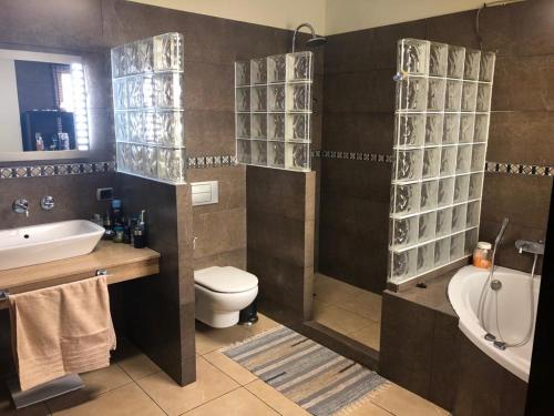 een badkamer met een toilet, een wastafel en een bad bij Casa M. in Candelaria