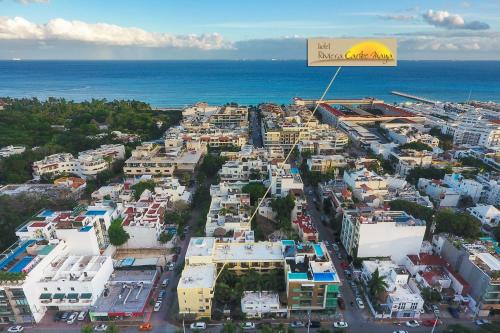 an aerial view of a city next to the ocean at Hotel Riviera Caribe Maya in Playa del Carmen