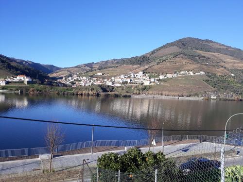 a view of a lake with a town and mountains at Casa da Padaria in Folgosa