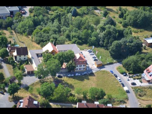 an aerial view of a house with a parking lot at Hotel Bruckertshof in Bamberg