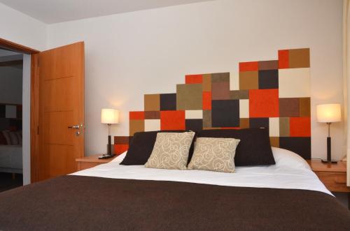a bedroom with a large bed with a colorful headboard at Amarras in Villa Pehuenia