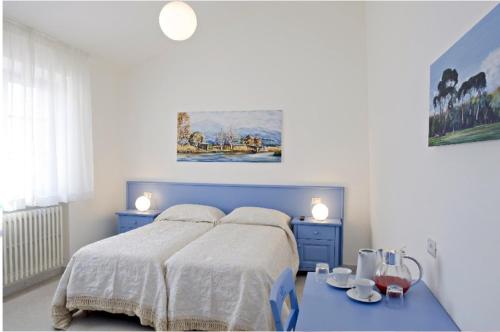 a bedroom with a blue bed and a blue table at LIù B&B in Torre del Lago Puccini