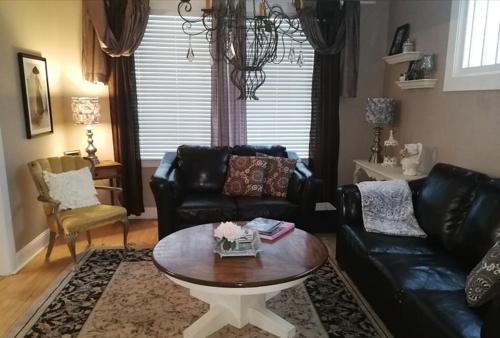 a living room with a couch and a coffee table at Charles Street Vacation Home in Lethbridge