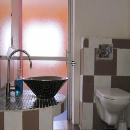 a bathroom with a sink and a toilet at EDEN BEACH SAINT-LOUIS in Saint-Louis