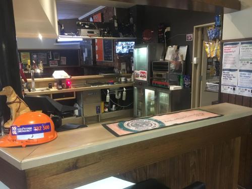 a counter in a coffee shop with an orange hat on it at Yarram Commecial Hotel Motel in Yarram