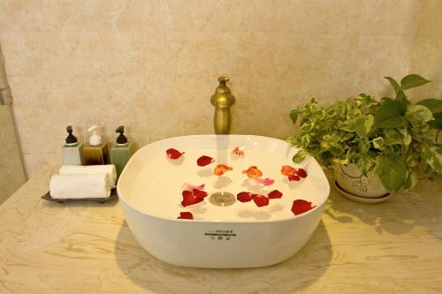 a bath tub with flowers in it on a counter at Sunrise Garden House - Luang Prabang in Luang Prabang