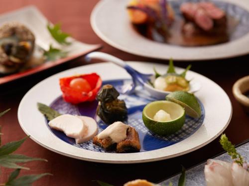 a table with three plates of food on it at Ryokan Shinsen in Takachiho
