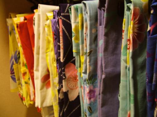 a bunch of shirts are hanging on a rack at Ryokan Shinsen in Takachiho