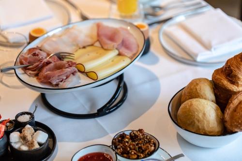 a table with a plate of food and bread at Hotel FRANQ in Antwerp