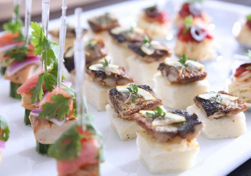 a plate of food with appetizers on tooth picks at Urban Hotel Kyoto in Kyoto