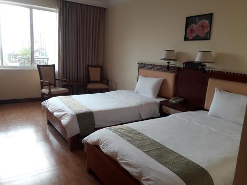 Postel nebo postele na pokoji v ubytování Stung Sangke Hotel