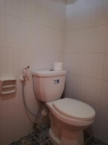 a bathroom with a toilet with a hose at Vievan's transient house in Alaminos
