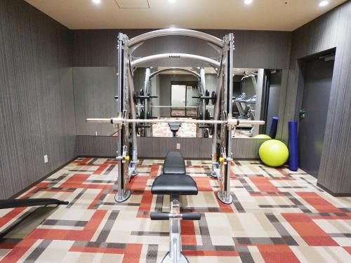 a gym with a weight room with two weights at Hotel Abest Grande Okayama in Okayama