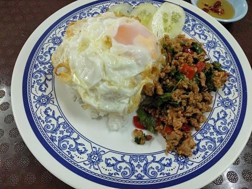 a blue and white plate of food with eggs and rice at Amatara Hotel in Pi Mai