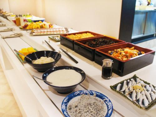 a buffet with different types of food on a table at Hotel Abest Grande Okayama in Okayama