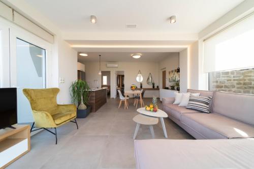a living room with a couch and a table at Sea La Vie in Adelianos Kampos
