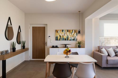 a living room with a table and a couch at Sea La Vie in Adelianos Kampos