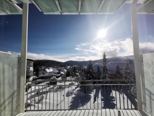 a view from the balcony of a house with the snow at Parkhotel Flora am Schluchsee in Schluchsee