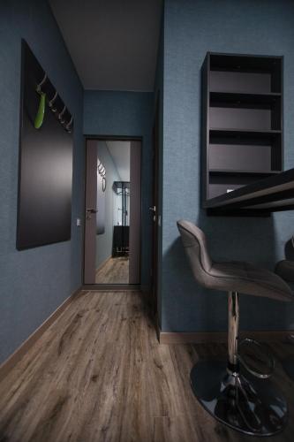 a room with a hallway with a chair and a mirror at Solo Apartment Kamenskaya in Kyiv