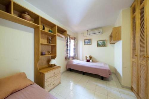 a bedroom with a bed and a dresser in it at Bungalow El Mar in Teguise