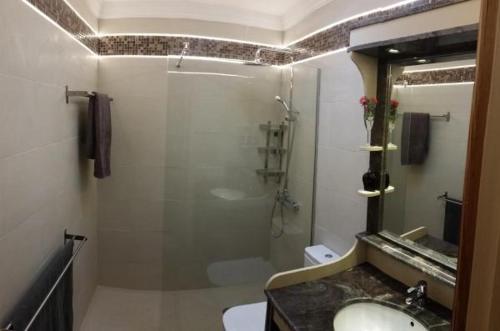 a bathroom with a shower and a sink and a mirror at Bungalow El Mar in Teguise