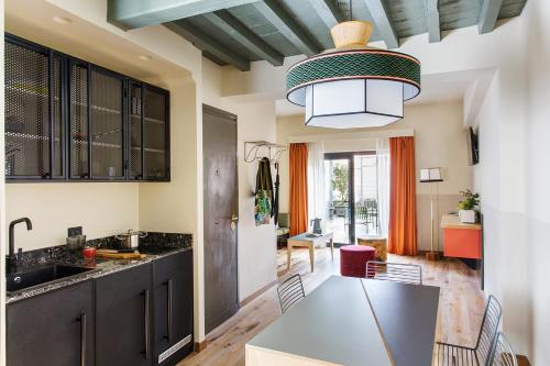 a kitchen with a refrigerator, stove, sink, and dishwasher at Condominio Monti Boutique Hotel in Rome
