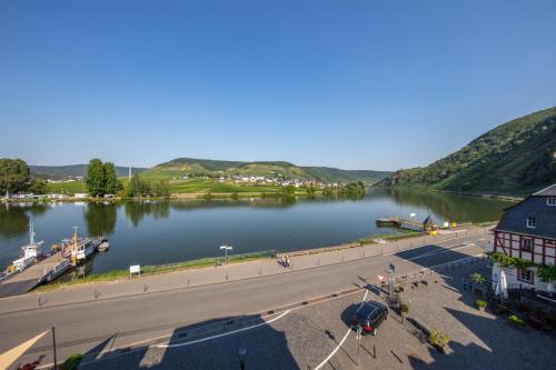 a view of a river with a building and a street at Villa Beilstein in Beilstein