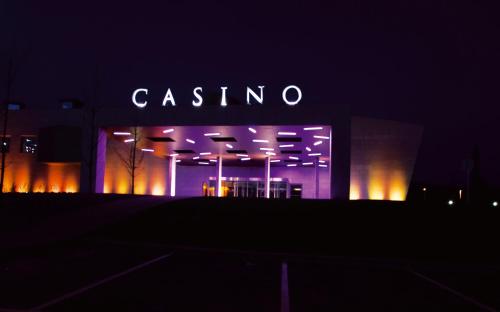 a building with a lit up sign on it at night at Hotel Casino Chaves in Chaves