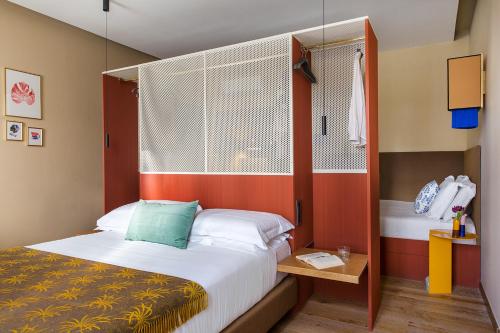 a small bedroom with a bed and a window at Condominio Monti Boutique Hotel in Rome