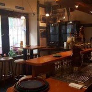 a bar in a restaurant with a counter and stools at Weingasthaus zum Fährhof in Winningen