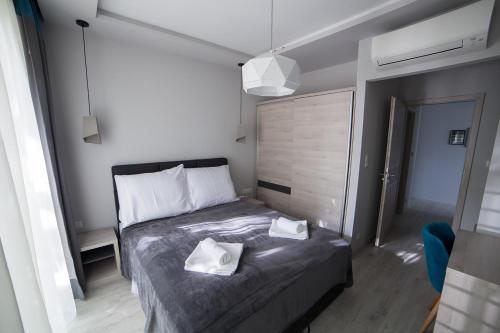 a bedroom with a bed with two towels on it at Villa Mango 2 in Balatongyörök