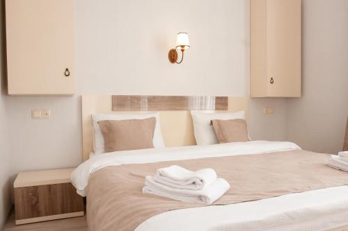 a bedroom with two beds with white towels on them at Hotel Casa calda in Kutaisi