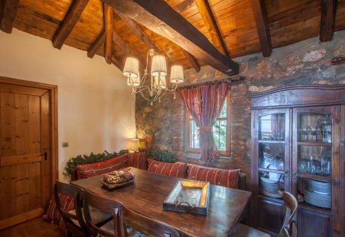 a dining room with a wooden table and chairs at Villa Palaios Agios Athanasios in Palaios Agios Athanasios