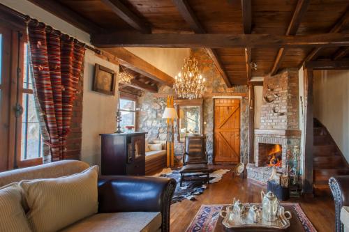 a living room with a couch and a fireplace at Villa Palaios Agios Athanasios in Palaios Agios Athanasios