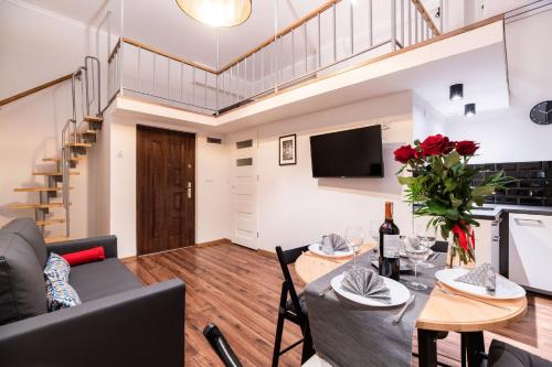 a living room with a table and a couch at DIETLA 99 APARTMENTS - IDEAL LOCATION - in the heart of Krakow in Kraków