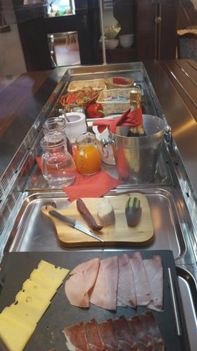 a tray of food with meat and cheese on a table at Hotel Schwarzbachhof in Lutago