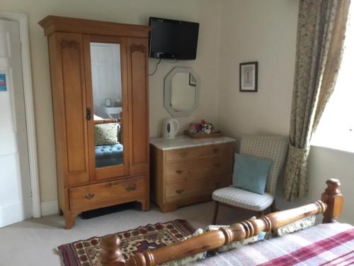 1 dormitorio con tocador y espejo en Lee-Side B&B, en Robin Hood's Bay