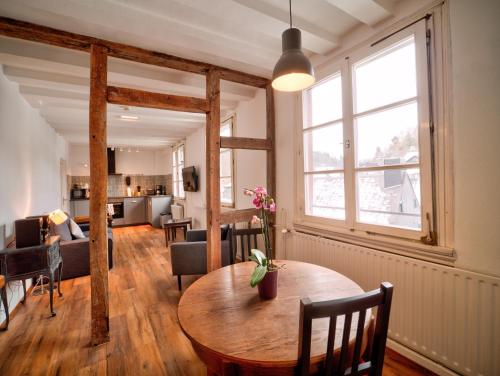 a living room with a wooden table and a couch at Haus Stehlings in Monschau