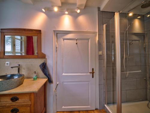 a bathroom with a shower and a sink and a door at Haus Stehlings in Monschau