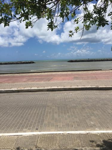 an empty street with the ocean in the background at Taverna do Paraiso in Janga