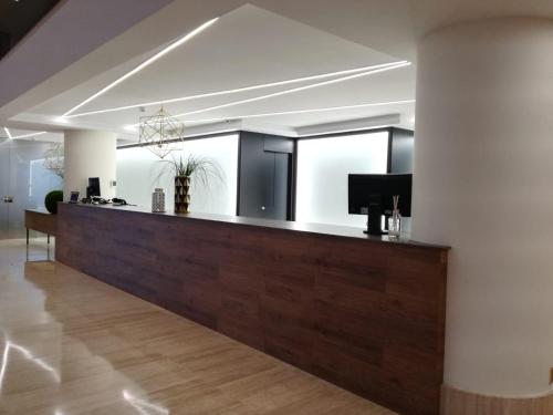 a lobby with a reception desk in a building at Oca Puerta del Camino Hotel in Santiago de Compostela