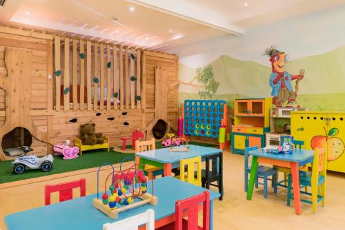 a childrens play room with tables and play equipment at Hapimag Ferienwohnungen St Michael in Sankt Michael im Lungau