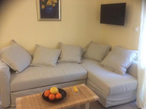 a living room with a couch with a bowl of fruit on a table at Kritikies Elyros in Pitsidia