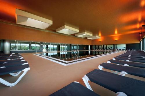 a large room with rows of chairs in it at Hotel Casino Chaves in Chaves