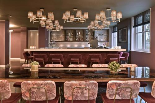 a restaurant with a bar with chairs and a counter at Zaan Hotel Amsterdam - Zaandam in Zaandam